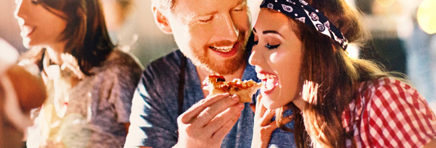 couple enjoying food at a festival